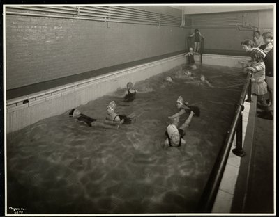Girls swimming at the New York Association for the Blind, 111 East 59th Street, New York, 1930 by Byron Company